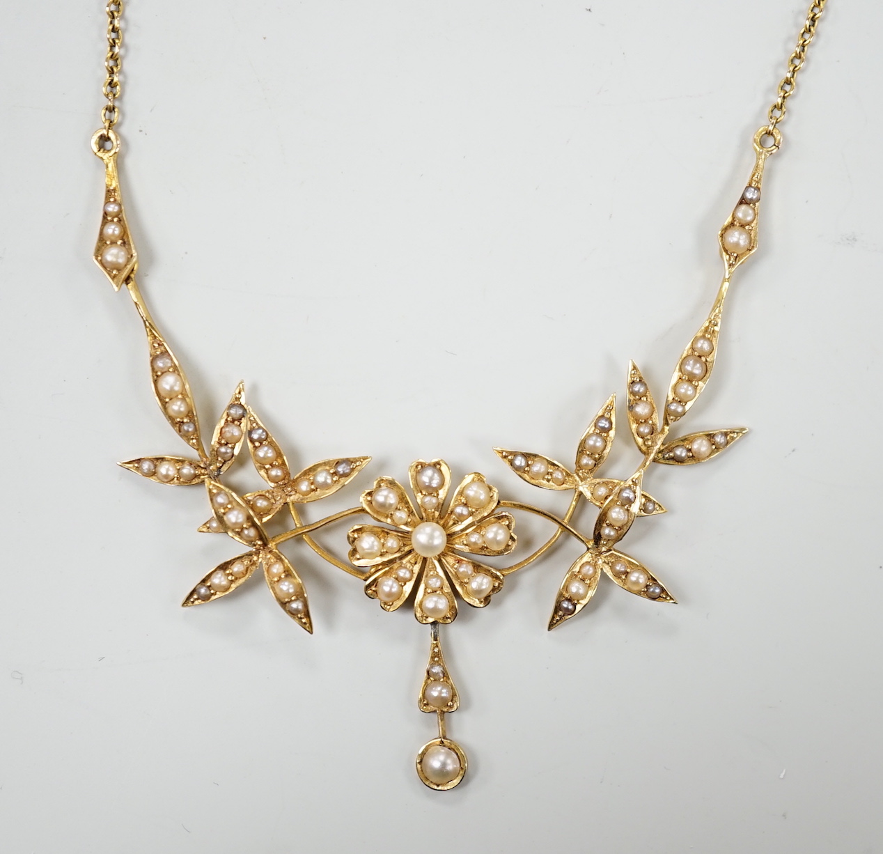 An Edwardian 15ct and seed pearl set drop necklace, 44.5cm, gross weight 8.6 grams.